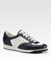 Lace-up sneaker with signature web and interchangeable laces. Blue leather with white nylon Rubber sole Made in Italy Please note: For best fit, please size down one full size.