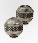 A pair of richly detailed platinum salt and pepper shakers are hand-embellished with faceted Swarovski crystals that add a jeweled touch to any table. From the Noir Collection Hand wipe Imported