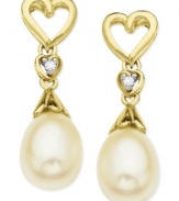 The look of love. A heart-shaped design, along with cultured freshwater pearls (6-8 mm) and diamond accents, helps make these earrings a pair to embrace. Crafted from 10k gold. Approximate drop: 3/4 inch.