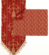 Prepare your table for an elegant meal with this Vase table runner, featuring an ornate vase pattern with leaves and flourishes all in dramatic red and gold hues. Finished with metallic gold trim for a chic touch.