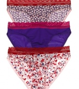 A solid or printed bikini with contrast scalloped lace trim along waistline.