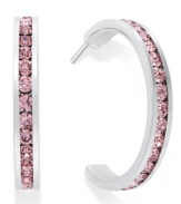 Traditions gives a sparkling boost to a simple pair of hoop earrings. A channel-set row of round-cut pink crystal with Swarovski elements shines within a sterling silver setting. Earrings feature a post and stud backing. Approximate diameter: 3/4 inch.