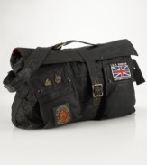 The iconic vintage motorcycle jacket is stylishly reincarnated as a sporty, patch-clad messenger bag, constructed with treated oilcloth for a waterproof finish.