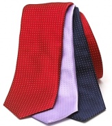 A wide silk tie embellished with a tonal pindot print.