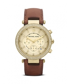 MICAHEL Michael Kors perfects boy-borrowed accessorizing with this classically styled watch. Its leather strap and over-sized face are handsome while a glitzy bezel adds a glamorous hint of femininity.