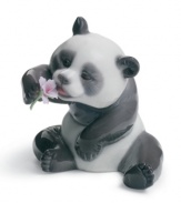 A cheerful panda trades his bamboo lunch in for a purple bloom in this irresistible Lladro collectible, handcrafted in fine porcelain.