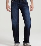 Suave straight leg jeans by Diesel in a robust dark wash, offset by bright orange stitching.