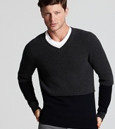 The v-neck sweater from Vince is rendered in soft merino wool, with contrast colorblock at the neck for a touch of texture.