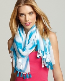 Add a touch of bright whimsy to any outfit with this oblong scarf in a turquoise and white Ikat pattern.