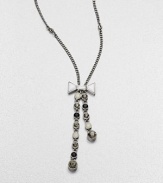 A long, graceful chain with an oxidized finish dangles a lariat of faceted stone strands, capped by a pretty bow.Glass and epoxy stonesOxidized rhodium finishLength, about 25Lobster claspImported