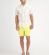 A vibrant summer essential, sport this garment dyed twill short with half-back elastic waist for added comfort.Flat-front styleSide slash, back welt pocketsInseam, about 6CottonMachine washMade in USA