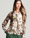 Usher in a romantic style sense in a ruffled Jones New York Collection blouse springing with painterly florals.