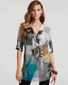 Mixed prints get dressed up with patches of sequins on Elie Tahari's Lori tunic, a silky style with graphic punch.