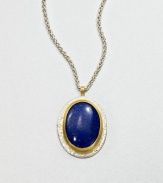 A beautiful, speckled lapis cabochon set in sterling silver and 24k gold on a link chain. LapisSterling silver24k goldLength, about 17.7Pendant size, about 1.2Lobster clasp closureImported 