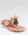 Faceted, sparkling jewels and a girlish bow add feminine flair to a pair of luxe-leather Vera Wang Lavender Label sandals.