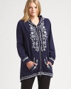 Exquisite embroidery completes this stretch-cotton look creating a flawless go-to piece. Pair this hooded tunic with simple pants.Attached hoodLong sleevesZipper frontFront pocketsAbout 30 from shoulder to hem95% cotton/5% spandexMachine washImported