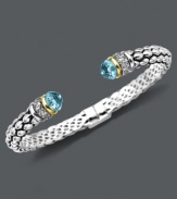 Cuff love. Pretty round-cut blue topaz (7 ct .t.w.) and sparkling diamonds (1/10 ct. t.w.) adorn the ends of this stunning open-cuff bracelet. Set in sterling silver with 14k gold accents. Approximate length: 7 inches.