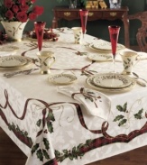 Season's greetings! Traditional holiday motifs of holly and ribbon adorn this durable cotton-blend tablecloth. A festive addition to your holiday décor you'll use year after year.