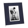 Display your treasured memories in a modern frame banded with silver and balanced with denim fabric.