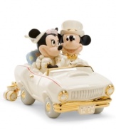 Honeymoon in Disney. Newlyweds Minnie and Mickey Mouse are the picture of happiness in a car is made for the occasion, with M&M vanity plates, luxe gold detail and cans tied to the bumper, all in beautiful Lenox porcelain.