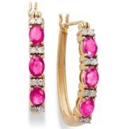 A color infusion. These 14k gold hoop earrings get a sparkling update with oval-cut rubies (1-1/5 ct. t.w.) and sparkling round-cut diamonds (1/8 ct. t.w.). Approximate diameter: 3/5 inch.