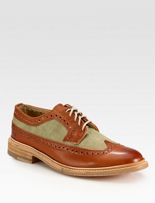 Classic wingtip style gets a contemporary update with contrasting textures, rendered with a smooth, genuine leather finish.Leather/canvas upperLeather liningPadded insoleLeather soleImported