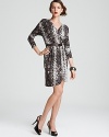 Ushering in this season's flair for the exotic, this MICHAEL Michael Kors dress enlivens your 9-to-5 style with sleek snake-skin print. Set off the tonal palette with flashes of silver for untamed glamour.