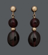 Get a double dose of style in rich, red hues. These daring drops feature two, graduated (6 mm and 6 mm x 8 mm), garnet beads (14 ct. t.w.) in a 14k gold post setting. Approximate drop: 3/4 inch.