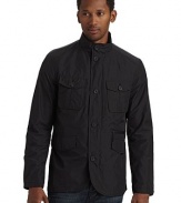 A stylish way to conquer the elements, this waterproof design keeps you dry and comfortable with roomy exterior pockets for increased functionality.Stand collar Front zipper with button storm flap Long sleeves with button cuffs Dual button flap pockets One zip pocket Dual flap pockets Two inside zip pockets Partially lined About 27½ from shoulder to hem Polyester Hand wash Imported