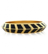 A pattern with panache. Vince Camuto's bangle bracelet is crafted from gold-tone mixed metal and black enamel with a bold chevron design for a stylish touch. Approximate diameter: 3-1/2 inches.