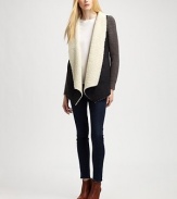 Modern take on the classic coat, this suede like design is styled with contrasting knit sleeves and plush faux shearling trim. Faux shearling shawl collarLong knit sleevesAdjustable back cordFaux shearling liningBody: PolyesterTrim: 50% acrylic/30% wool/20% nylonHand washImportedModel shown is 5'10 (177cm) wearing US size Small.