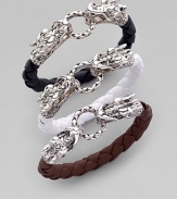 From the Naga Collection. Symbolizing power and the life force in many cultures, two richly detailed sterling silver dragon heads, joined by a bracelet of braided leather, play tug of war with a braided ring clasp. Sterling silver Woven leather Diameter, about 2¼ Width, about ¼ Dragon spring clasp Made in Bali Please note: Bracelets sold separately.