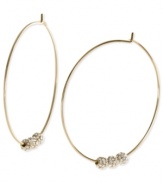 Michael Kors adds an elegant touch to its pair of hoop earrings. Crafted from gold ion-plated mixed metal, the earrings feature glass pave fireballs for a lustrous touch. Approximate diameter: 2 inches.