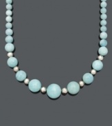 Smooth out your look in sweet, ocean-inspired style. This breezy necklace features graduated 8 to 20 millimeter aquamarine beads (480 ct. t.w.) with small, sterling silver accent beads and clasp. Approximate length: 18 inches.