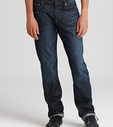 Slim fit jeans in a distressed dark wash for denim with a rugged attitude by J Brand.