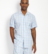 Change up your everyday evening look with this bright plaid camp shirt from Nautica.