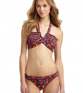 THE LOOKSpirited abstract animal and floral printAdjustable halter straps tie at neckBands crisscross at center with V-shaped openingPadded cups and side boningBack clasp closureTHE MATERIAL80% nylon/20% spandexFully linedCARE & ORIGINHand washImportedPlease note: Bikini bottom sold separately. 