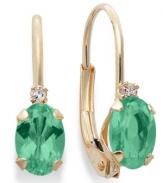 Sparkling perfection. Add a vibrant pop of color to your look with oval-cut emeralds (9/10 ct. t.w.) and sparkling diamond accents. Crafted in a 14k gold leverback setting. Approximate drop: 3/4 inch.