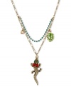 Reptilian fashion from Betsey Johnson. This pendant necklace features a gold tone chain with a blue-colored crystal cup chain. The alligator pendant features green-colored crystal eyes, pink bows, green leaf charm and small crystal accent. Crafted in antiqued gold tone mixed metal. Approximate length: 16 inches + 3-inch extender. Approximate drop: 2 inches.