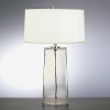 Table lamp with clear glass base. White organza fabric shade with self fabric top and bottom diffuser. Three way switch.