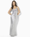 Exuding elegant appeal in a sweeping floor-length silhouette, a timeless dress is tailored with a sequined mesh overlay and cut with a sexy V-neckline for a glamorous finish.