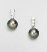 Three dazzling, graduated diamonds set in 18k white gold accent this rich Tahitian pearl drop design. 9mm round Tahitian pearlsDiamonds, .48 tcw18k white goldDrop, about .75Post backImported 