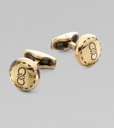 Round brass design engraved with iconic double gancini details, in a unique goldtone.BrassAbout ½ diam.Made in Italy