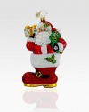 Hand-painted and glitter-dusted, an artfully crafted Santa of European glass rests inside an oversized boot. Hand-blownHand-painted5½ tallMade in Poland