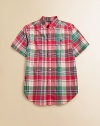 A tried-and-true button-front design is rendered in a vibrant madras plaid.Button-down collarShort sleevesButton frontBox-pleated backShirttail hemCottonMachine washImported Please note: Number of buttons may vary depending on size ordered. 