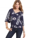 American Rag's slouchy-chic top features a feathery print that adds spice to your skinny jeans or colored cords!