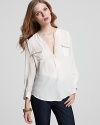 Joie's blouse in porcelain silk with camel trim equals a subtle refinement on the pale top trend.