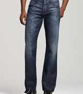 These 7 for All Mankind straight leg jeans sits low with a straight waist band, and slim leg opening. Unraveled squiggle in dark embroidery on back pockets.