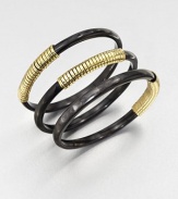 A set of three horn bangles wrapped in shiny brass wire. Recycled ankole cow hornRecycled brassDiameter, about 2.5Slip-on styleImported 