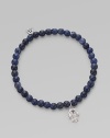 The hamsa, a traditional protective amulet, is encrusted with diamonds and accented with one sapphire as it hangs from a stretchy strand of deep-toned sodalite beads. Diamonds, 0.05 tcw Sodalite 14k white gold Diameter, about 2 (unstretched) Charm length, about ½ Imported